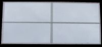 Four 50x25mm Silver MF7 Mirror Mosaic Tiles Pictured Reflecting the Sky on an Overcast Day